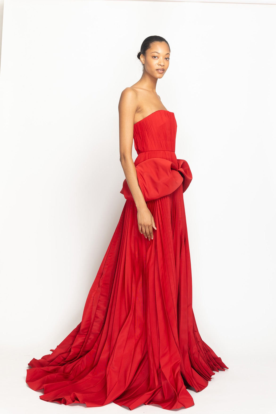 Sindoor Faille and Pleated Chiffon Strapless Gown with Moulded Hip Drape and Pleated Skirt Side One