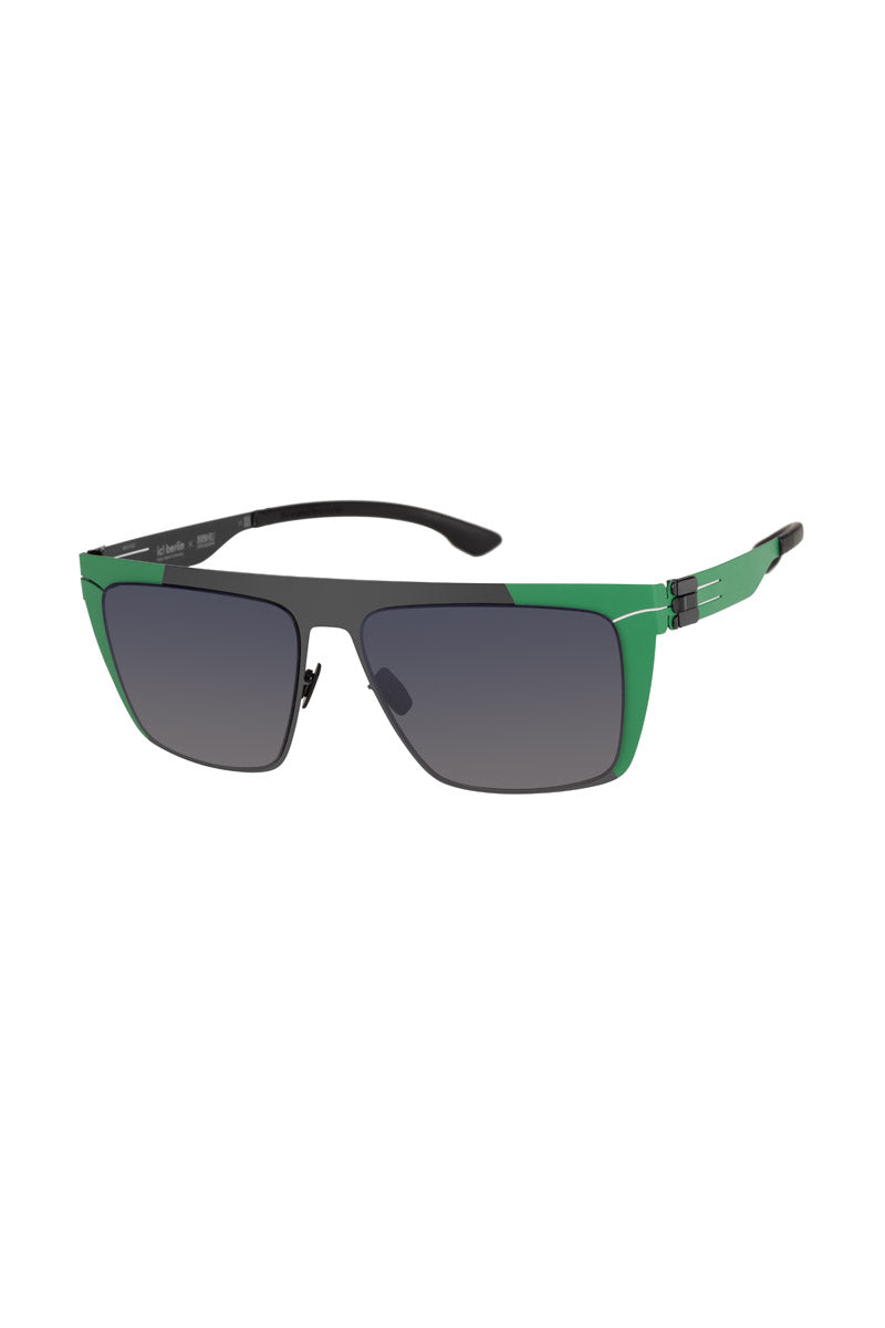 Runway model wearing Bibhu 01 green and black sunglasses side view